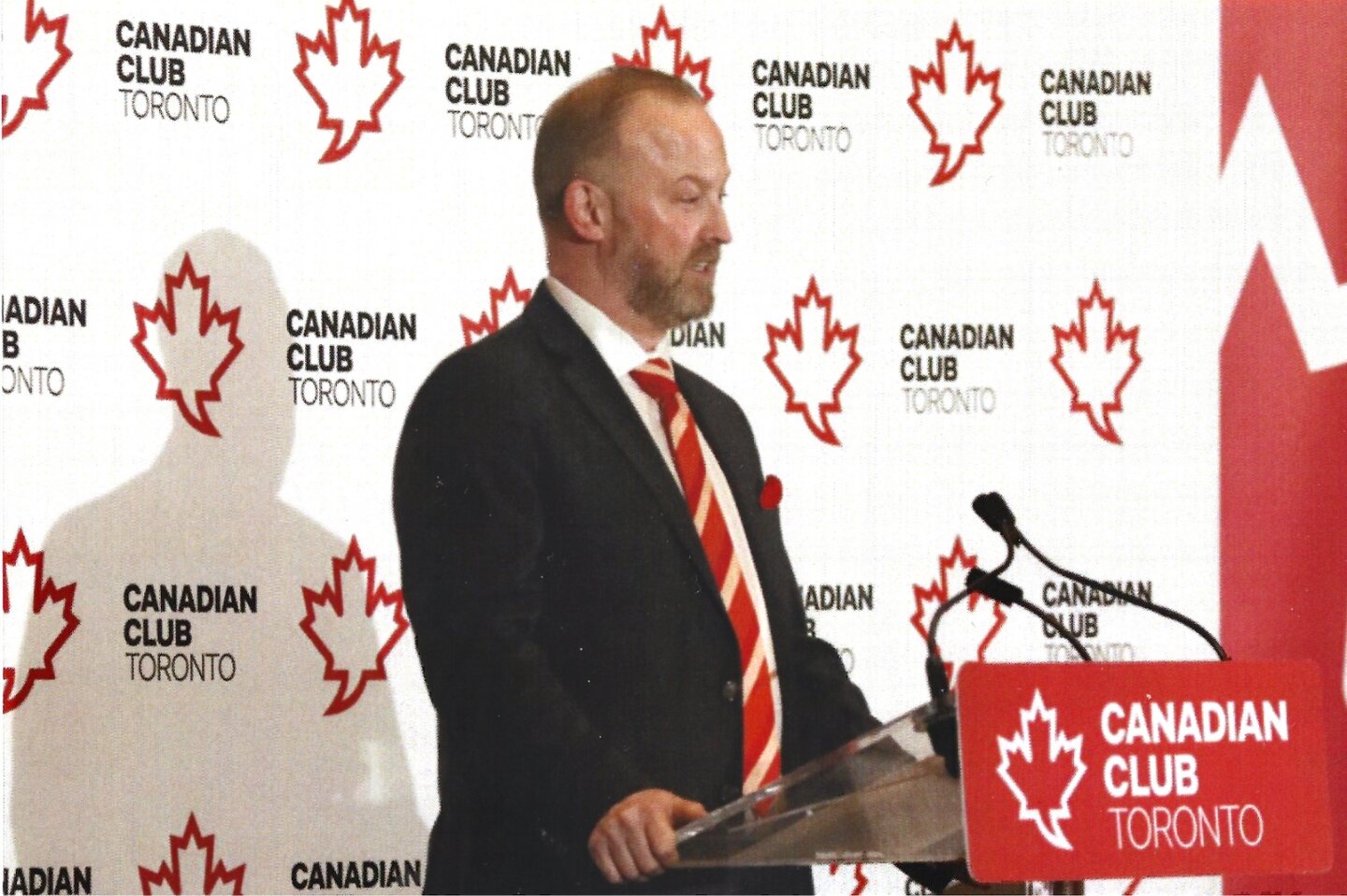 Michael Bach speaking at the Canadian Club podium