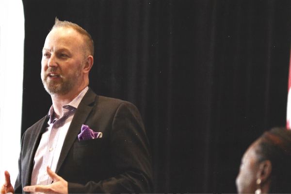 Michael Bach mid-gesture onstage